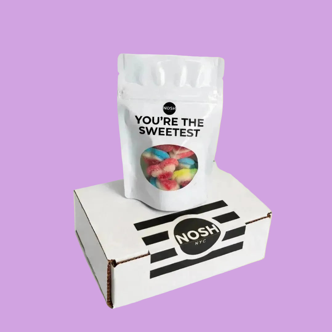 NOSH NYC candy bag with 'You're the Sweetest' text on a white box against a light green background